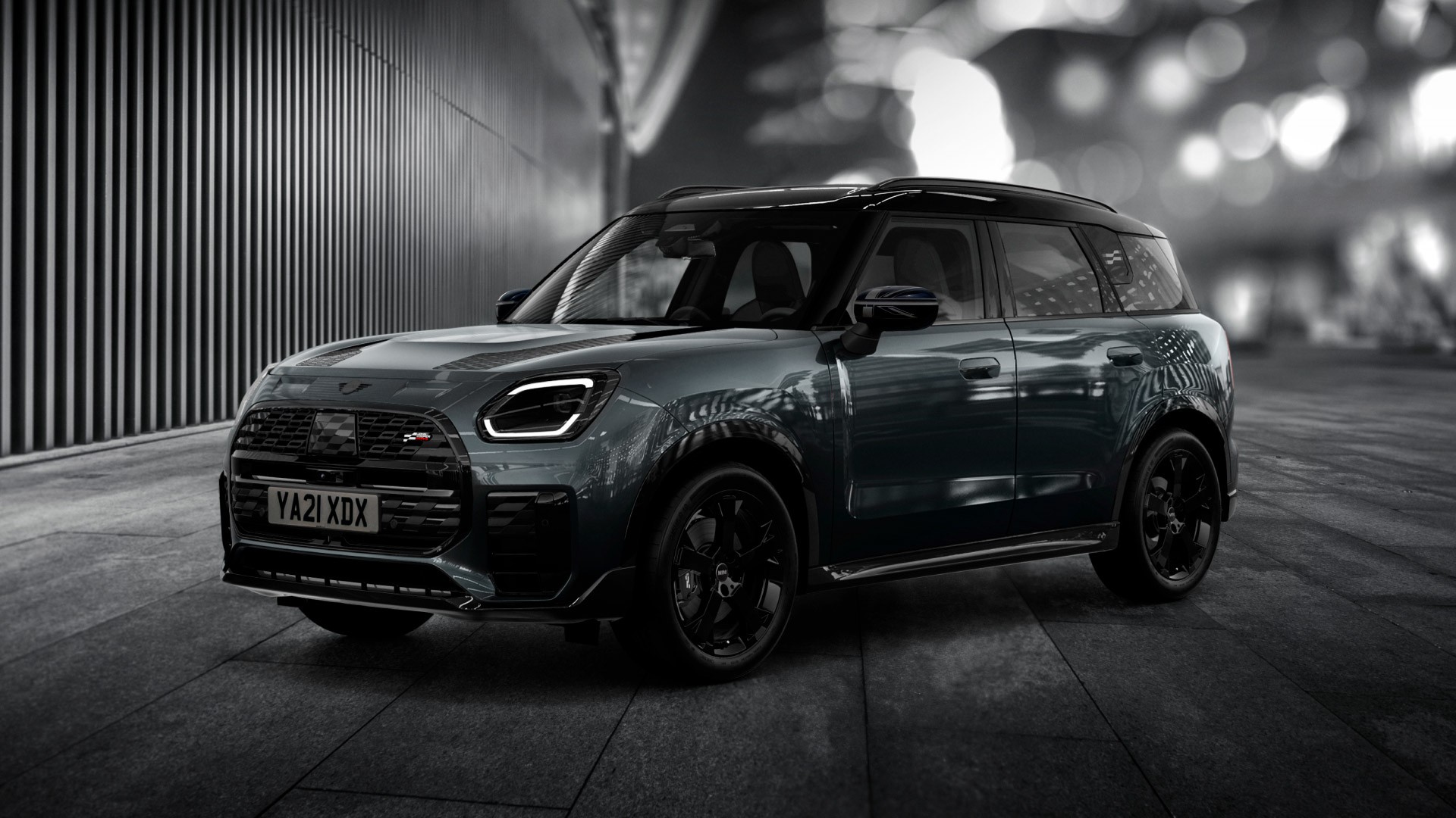 The MINI Countryman Shadow Edition gleams brightly on a nighttime street corner.